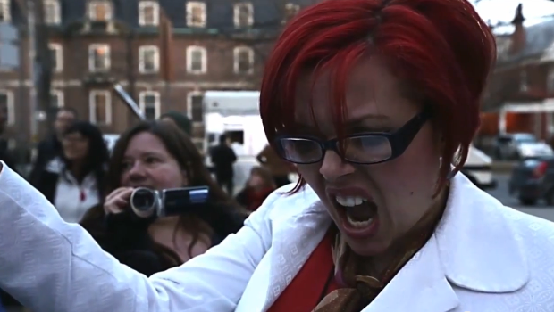 feminist shouting angrily at a protest